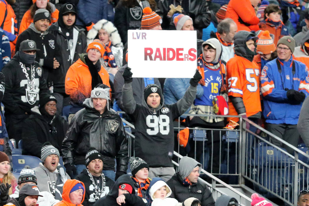 An Oakland Raiders fan holds up a sign during the second half of an NFL game against the Denver ...