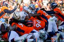 Oakland Raiders running back Alec Ingold, above center, is stopped before the goal line during ...