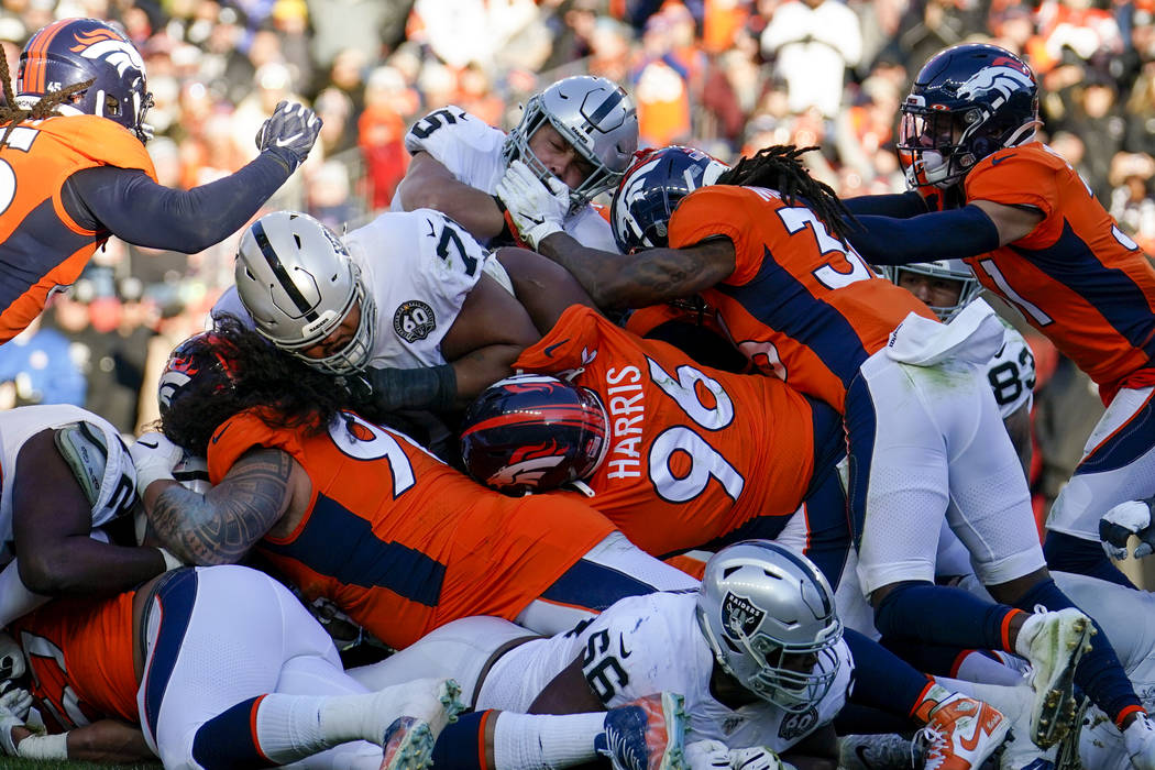 Oakland Raiders running back Alec Ingold, above center, is stopped before the goal line during ...