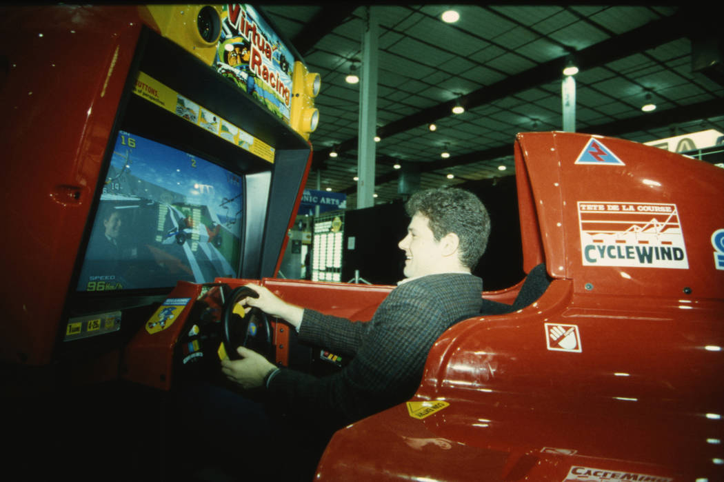 A showgoer gives Sega's "Virtua Racing" arcade game a spin at the 1993 CES. (Las Vegas Review-J ...