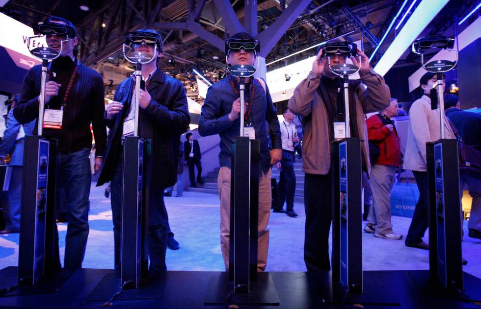Showgoers try out 3D glasses at the Panasonic booth during the 2010 Consumer Electronics Show. ...