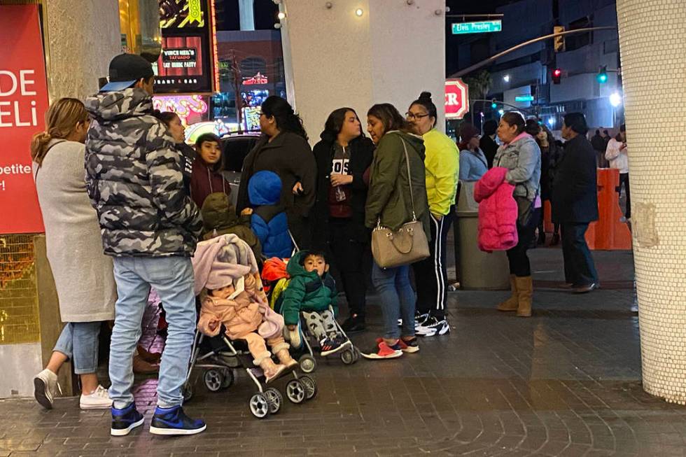 Families with strollers set up shop on Las Vegas Boulevard hoping to watch New Year's fireworks ...