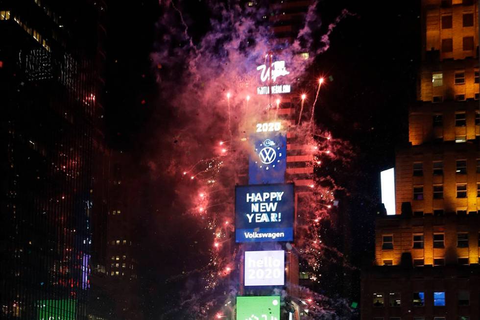 Confetti drops over the crowd as the clock strikes midnight during the New Year's celebration a ...