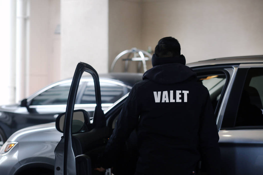A valet runner takes care of a guest with free valet parking at the Sahara Las Vegas on Friday, ...