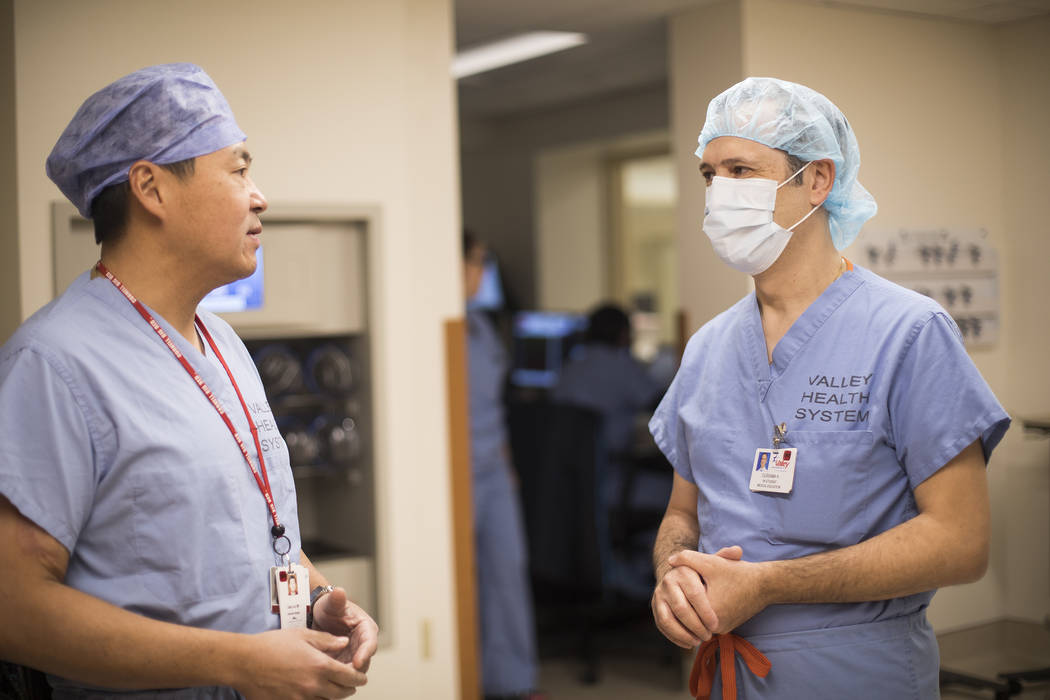 Dr. Eddy Luh, left, speaks with Dr. Oussama “Sam” Hajal, right, who worked for mo ...