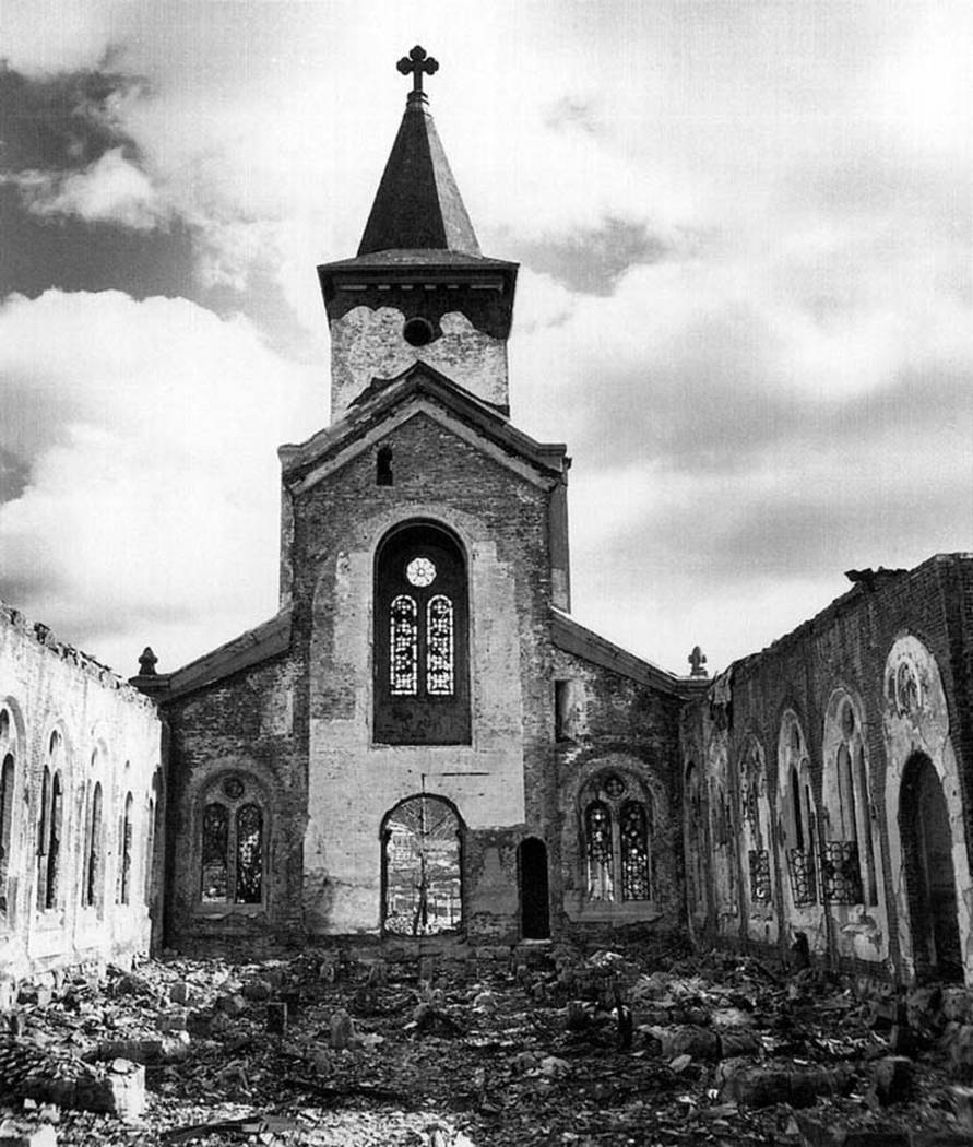 A Christian church, many of it's stained glass windows still intact, is shown in this photograp ...