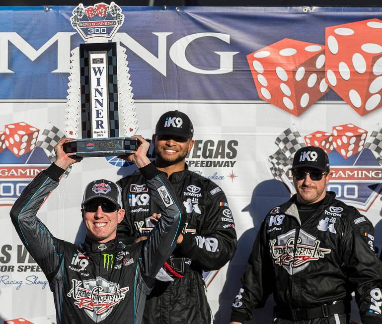 Kyle Busch, left, hoists the trophy for winning the NASCAR Xfinity Series Boyd Gaming 300 on Sa ...