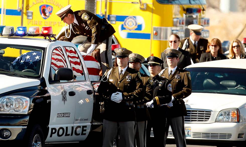 The casket of slain court security officer Stan Cooper arrives with full escort for a funeral s ...