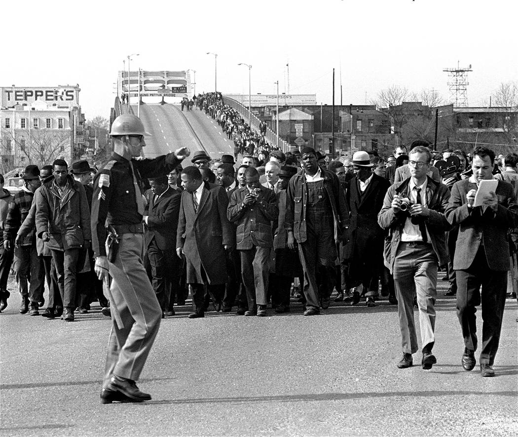 Dr. Martin Luther King, Jr., and his demonstrators stream over an Alabama River bridge at the c ...