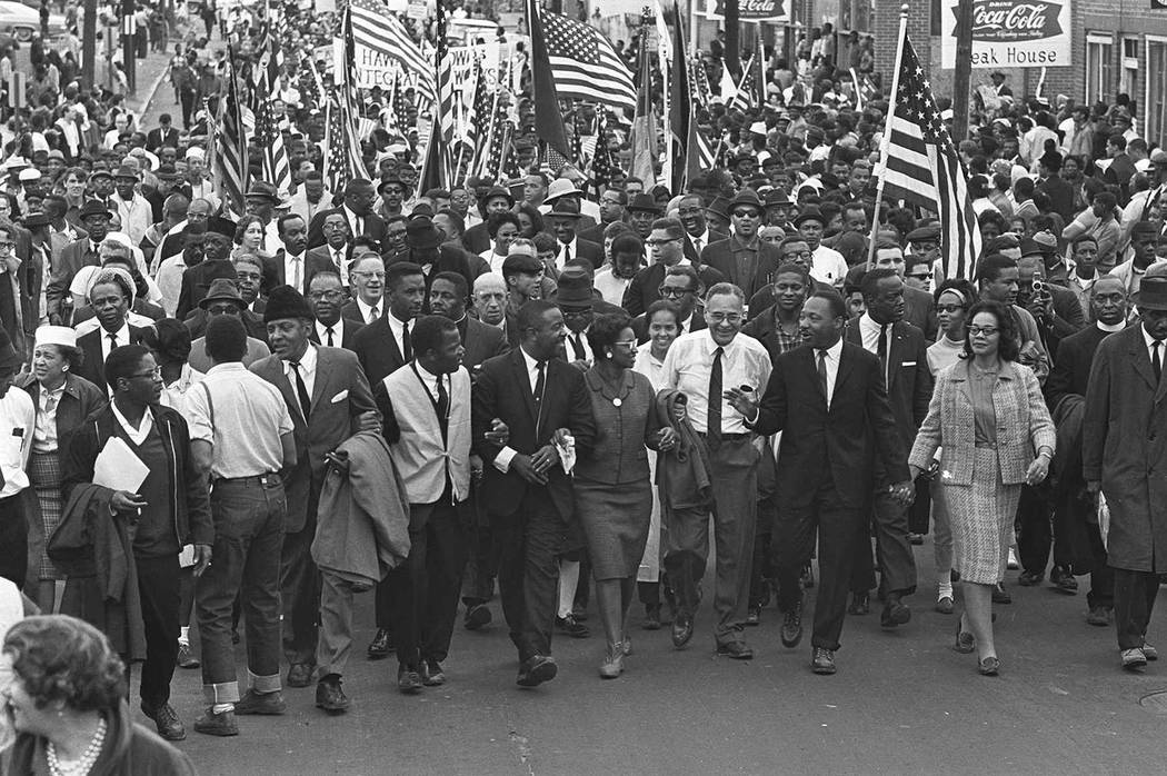Dr. Martin Luther King, third from right, marchers across the Alabama River on the first of a f ...
