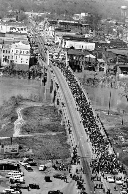 Marchers cross the Alabama river on the Edmund Pettus Bridge at Selma on March 21, 1965. The c ...