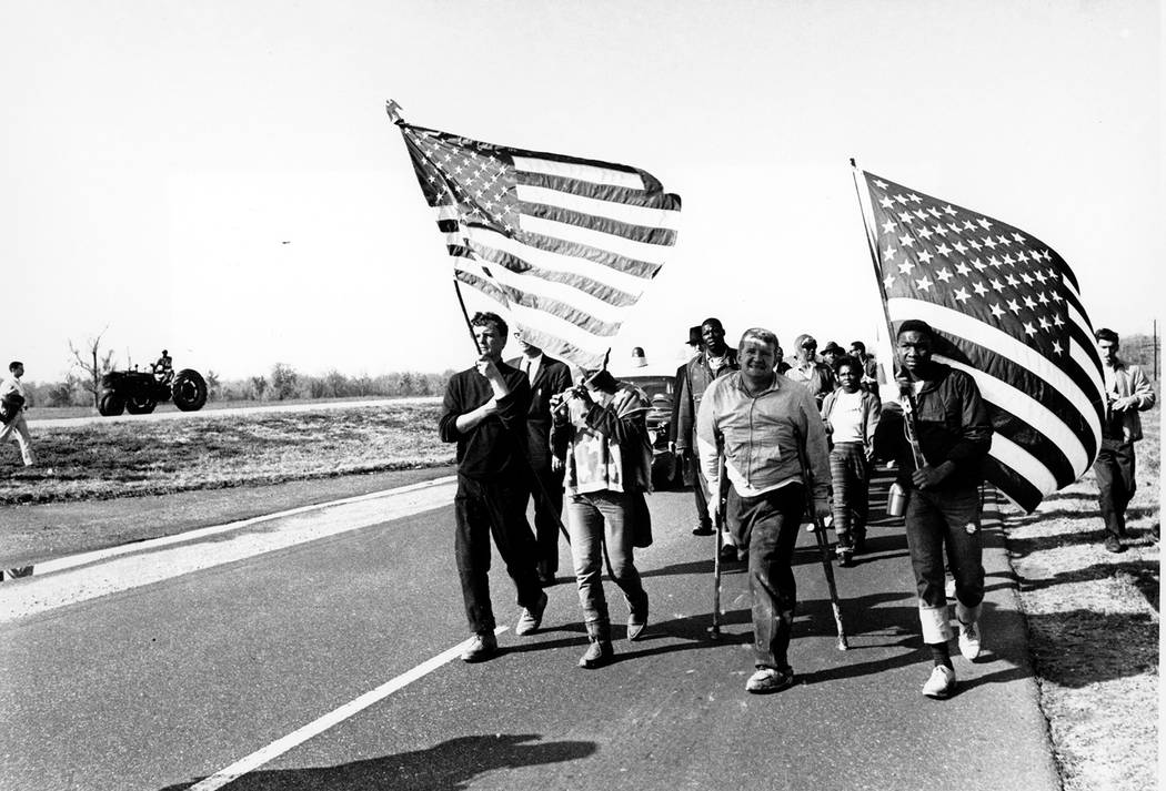 Civil rights marchers carry flags and play the flute as they approach their goal of Montgomery, ...