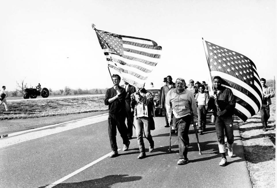 Civil rights marchers carry flags and play the flute as they approach their goal of Montgomery, ...