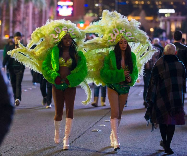 Show girls walk the Strip on Tuesday, Dec. 31, 2019, in Las Vegas. (Benjamin Hager/Las Vegas Re ...