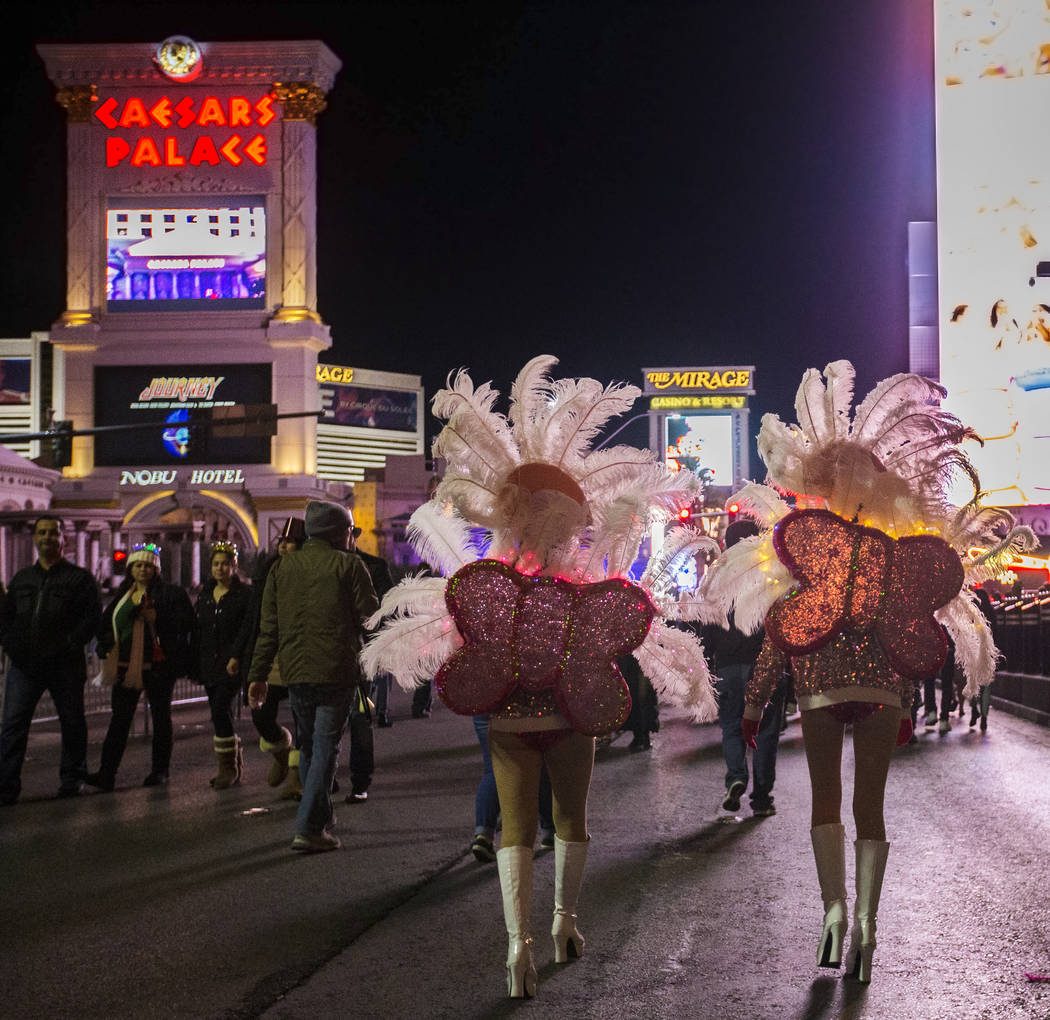 Show girls walk the Strip on Tuesday, Dec. 31, 2019, in Las Vegas. (Benjamin Hager/Las Vegas Re ...