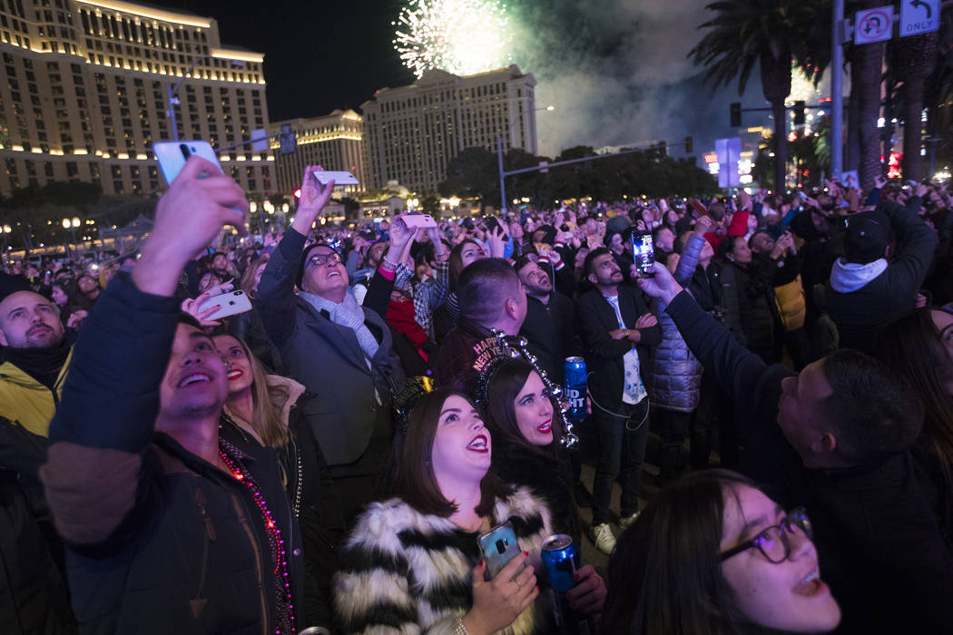 Revelers watch fireworks on New Year’s Eve in Las Vegas, Wednesday, Jan. 1, 2020. (Rache ...