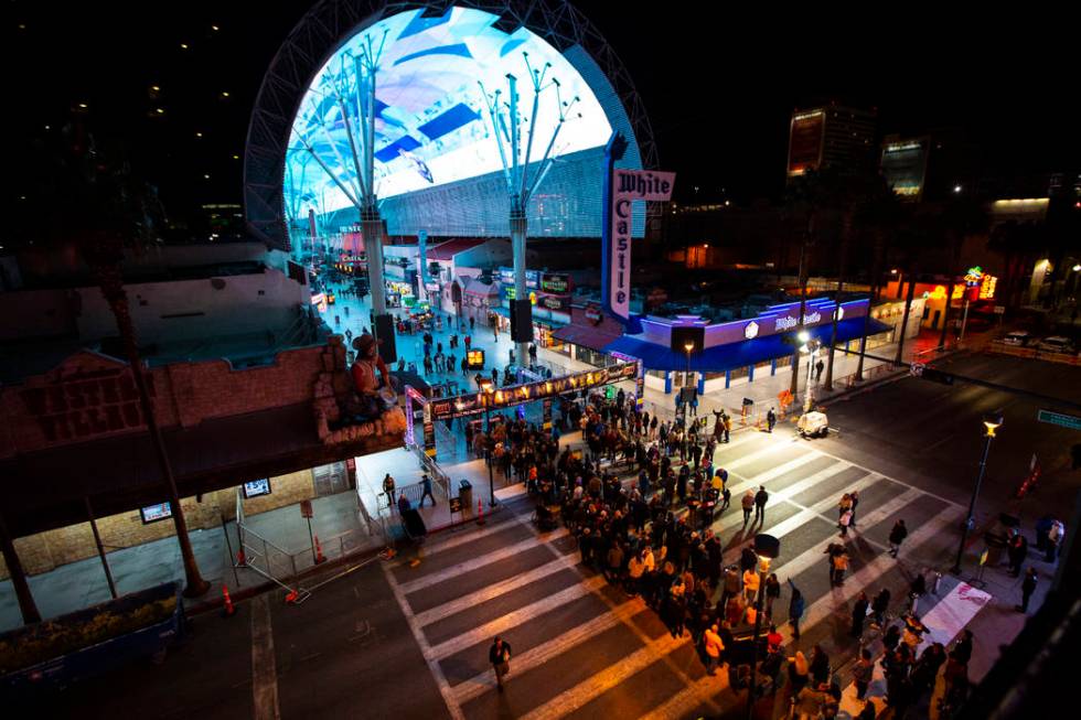 New Year's Eve revelers line up to enter the Fremont Street Experience in downtown Las Vegas on ...