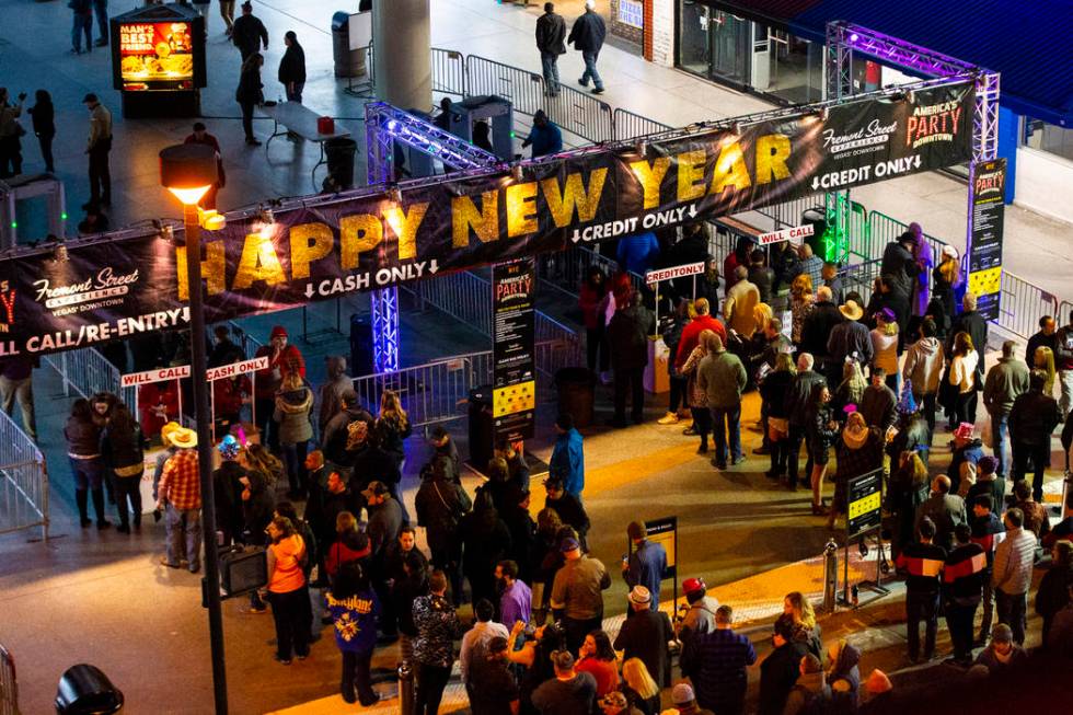 New Year's Eve revelers line up to enter the Fremont Street Experience in downtown Las Vegas on ...