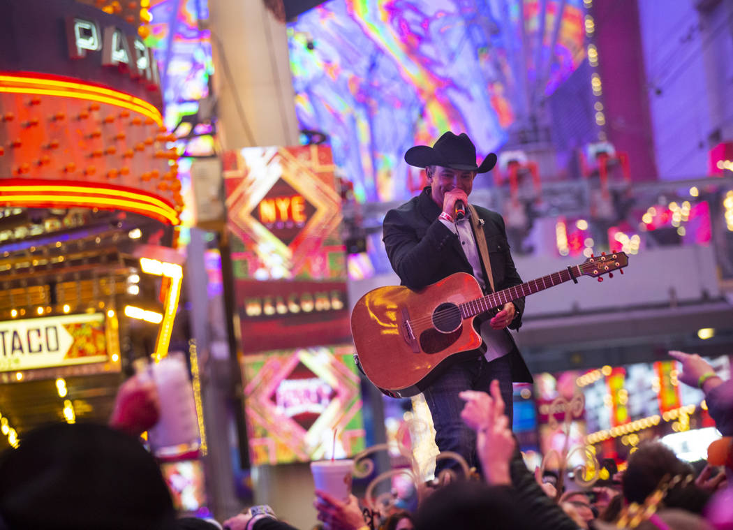 Tony Marques performs as New Year's Eve revelers gather at the Fremont Street Experience in dow ...