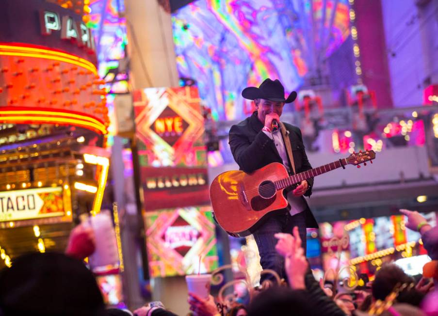 Tony Marques performs as New Year's Eve revelers gather at the Fremont Street Experience in dow ...