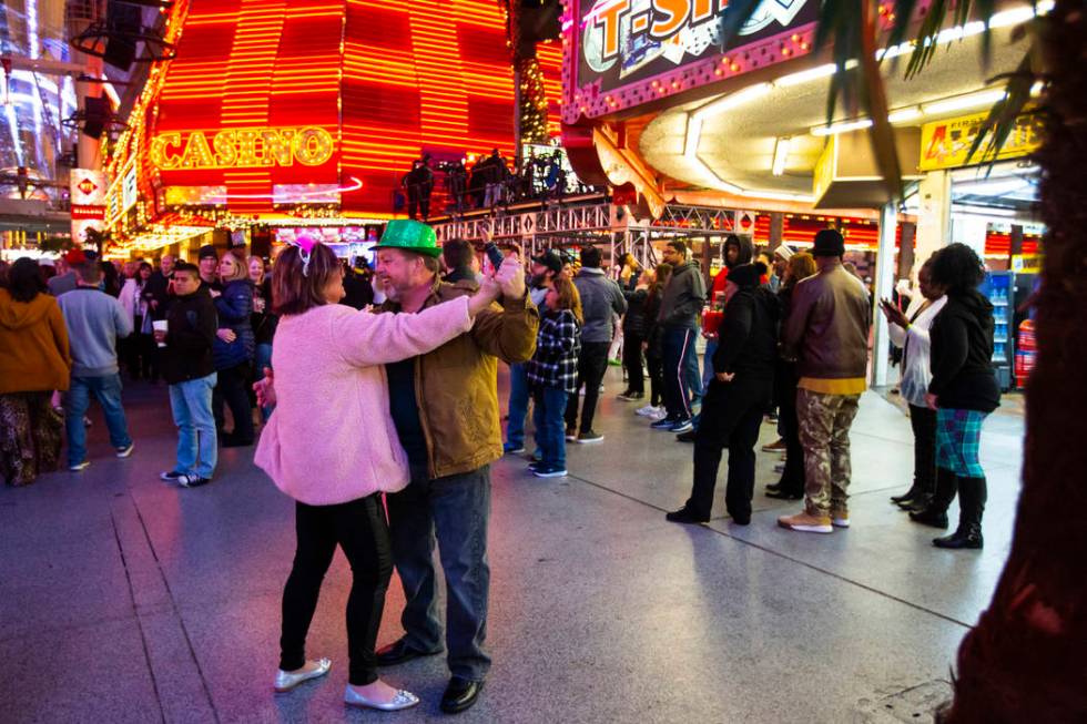 Sherry Schneider, left, of South Carolina, dances with Rob Schneider as New Year's Eve revelers ...