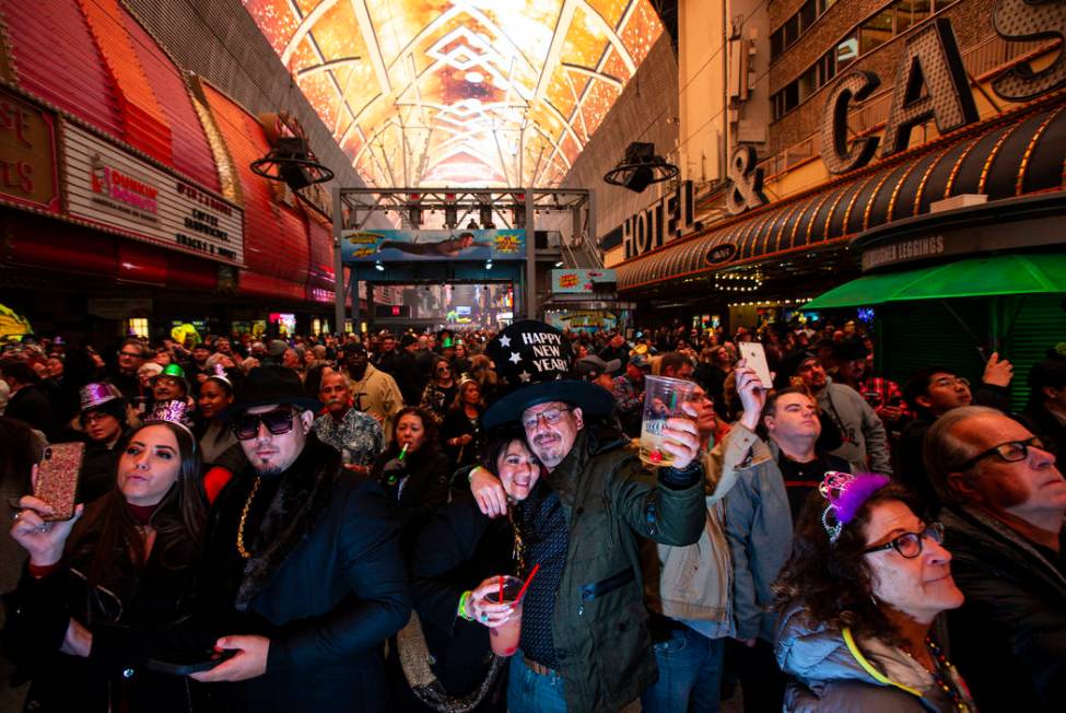 Revelers, including Karrie Wagner and James Green, of Dallas, center, celebrate during a New Ye ...