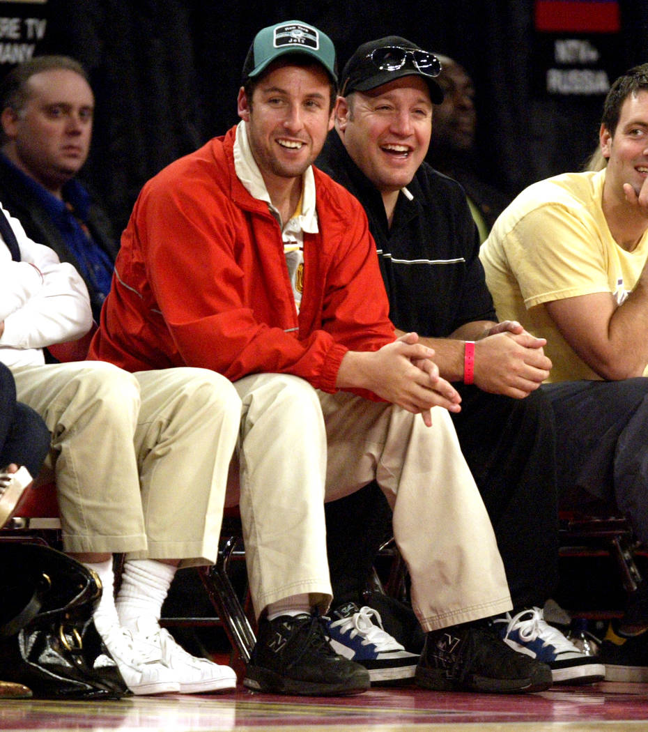 Actor Adam Sandler, left, and Kevin James laugh during the NBA All-Star basketball game at the ...