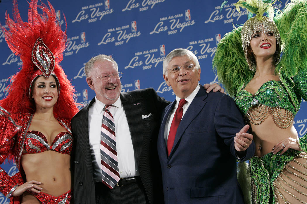 Las Vegas showgirls flank Las Vegas Mayor Oscar Goodman, left, and Commissioner of the National ...