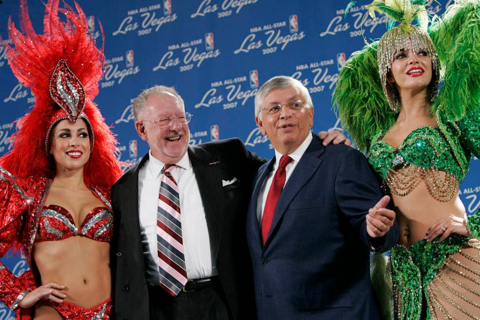 Las Vegas showgirls flank Las Vegas Mayor Oscar Goodman, left, and Commissioner of the National ...