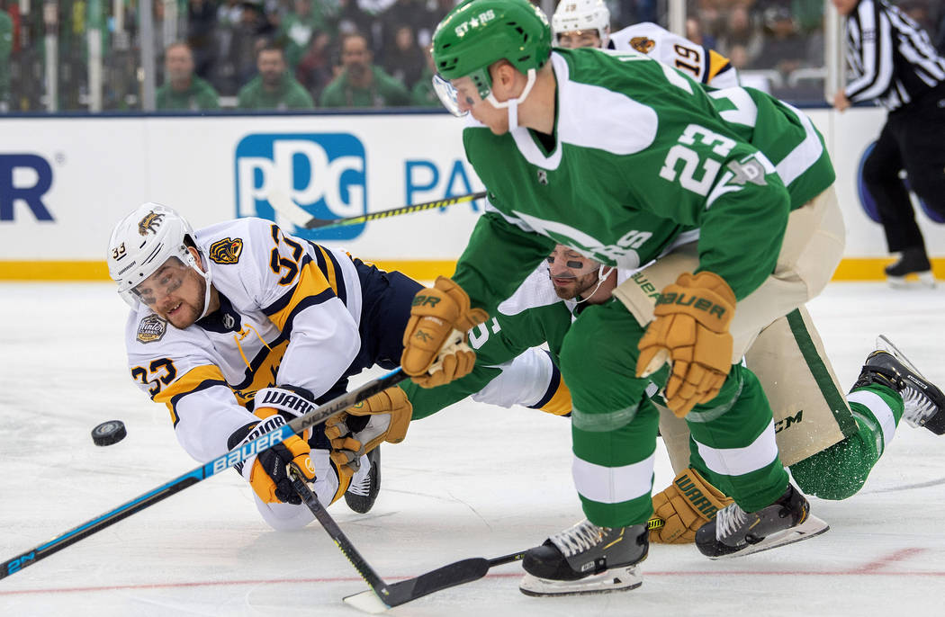 Nashville Predators right wing Viktor Arvidsson (33) dives to the ice as he competes for the pu ...