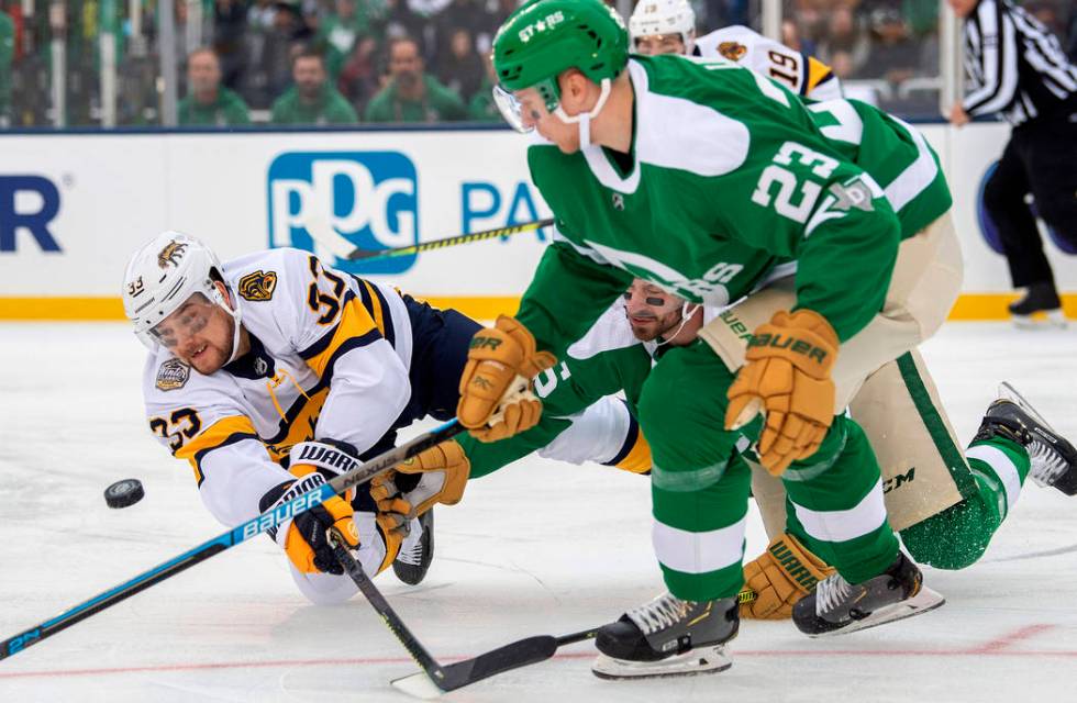 Nashville Predators right wing Viktor Arvidsson (33) dives to the ice as he competes for the pu ...