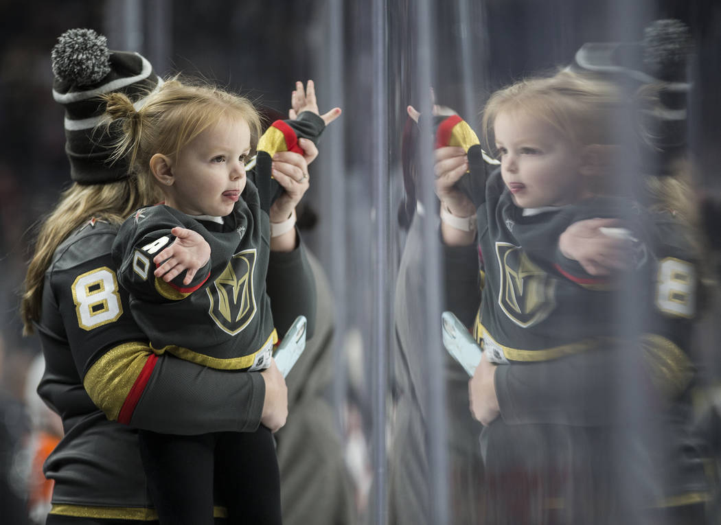 Golden Knights fans cheer for Vegas in the second period of an NHL hockey game against the Phil ...