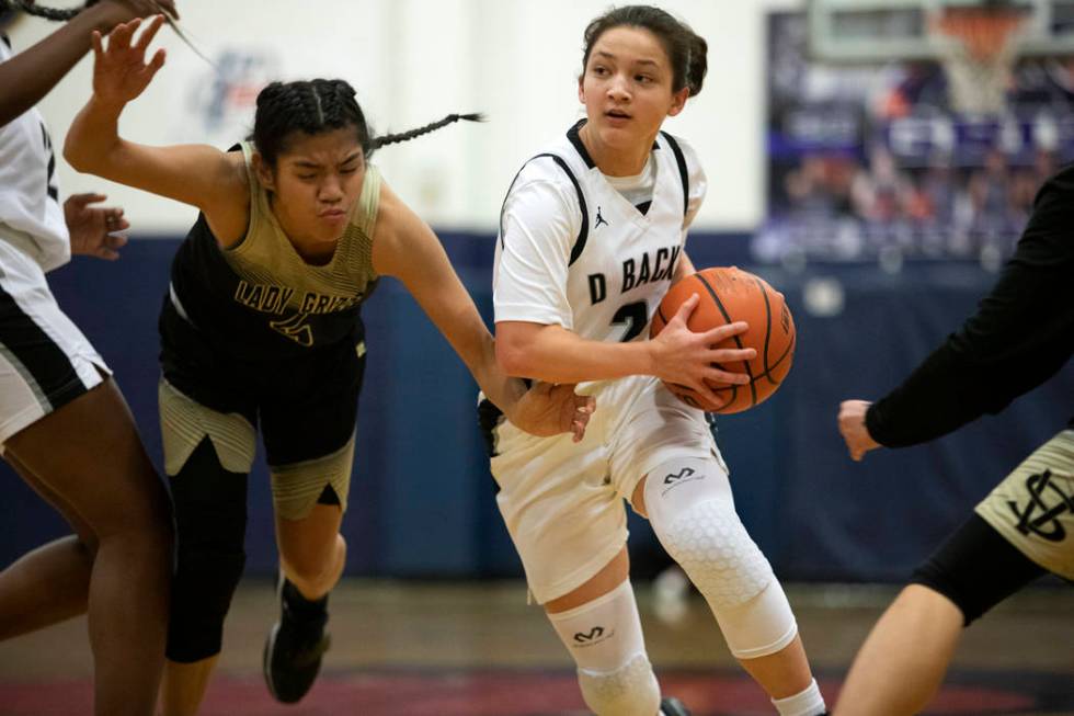 Spring Valley guard Chelsea Camara, left, defends against Desert Oasis guard Isabella Jaramillo ...