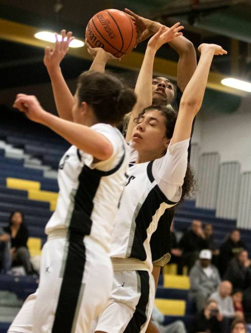 Spring Valley's forward Aaliyah Gayles (3) shoots a point as Desert Oasis's guard Autiyjah Pric ...