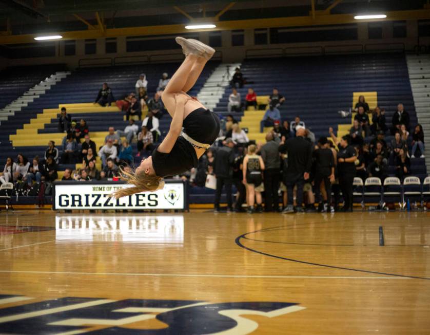 The Spring Valley High School cheerleading squad does flips during a timeout during the basketb ...