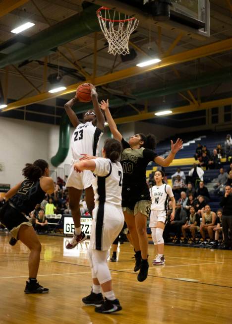 Desert Oasis's forward Desi-Rae Young (23) blocks a Spring Valley point as Spring Valley's guar ...