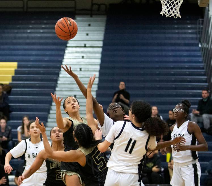 Spring Valley's guard Garrisen Freeman (32) tosses a shot toward the basket during the game aga ...