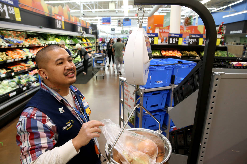 Personal shopper Melvin Oasay fills customer orders for pickup at Walmart at 7200 Arroyo Crossi ...