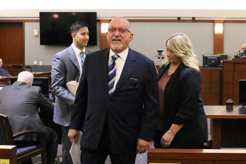Las Vegas defense attorney Dominic Gentile, center, leaves a Regional Justice Center courtroom ...