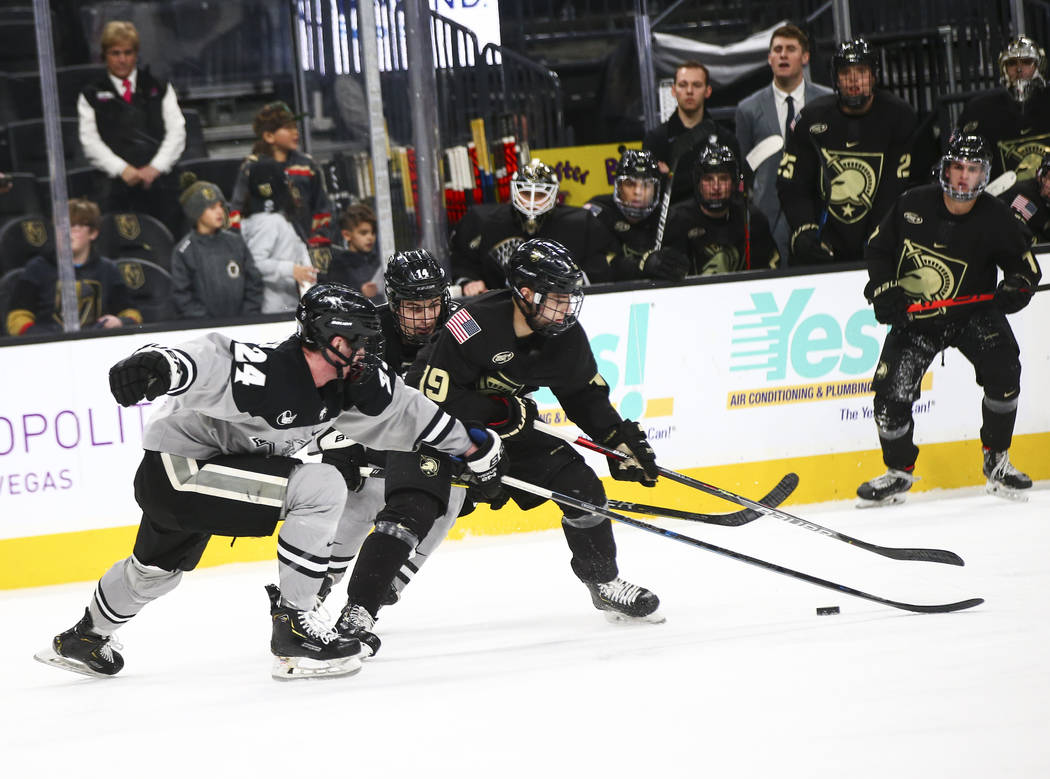 Army Black Knights' forward Brett Abdelnour (19) battles for the puck between Providence Friars ...