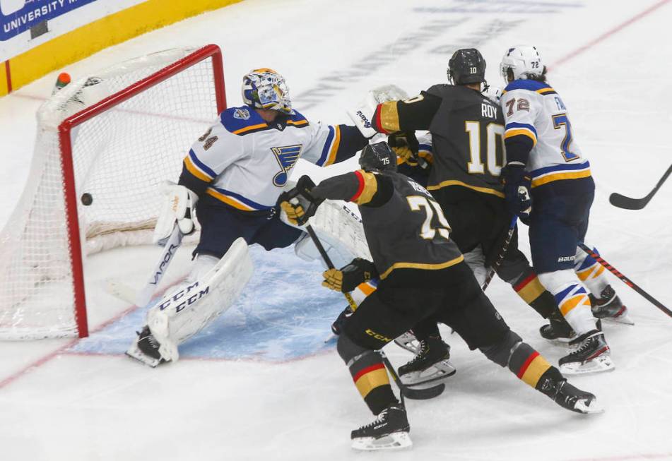 Golden Knights' Nicolas Roy (10) sends the puck past St. Louis Blues goaltender Jake Allen (34) ...