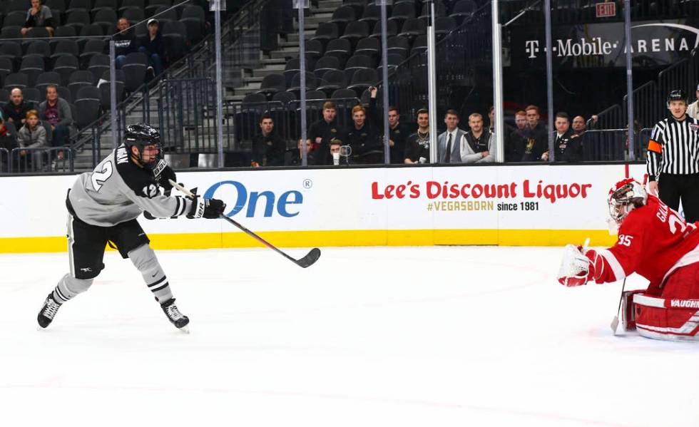 Providence Friars' Jack Dugan (12) scores past Cornell Big Red goaltender Matthew Galajda (35) ...