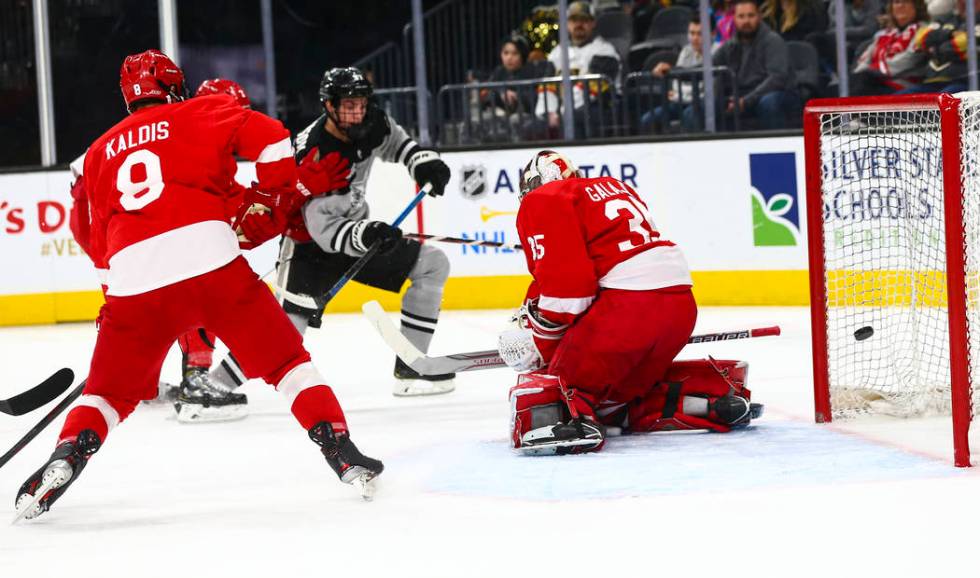 Providence Friars' Tyce Thompson (27) sends the puck past Cornell Big Red goaltender Matthew Ga ...