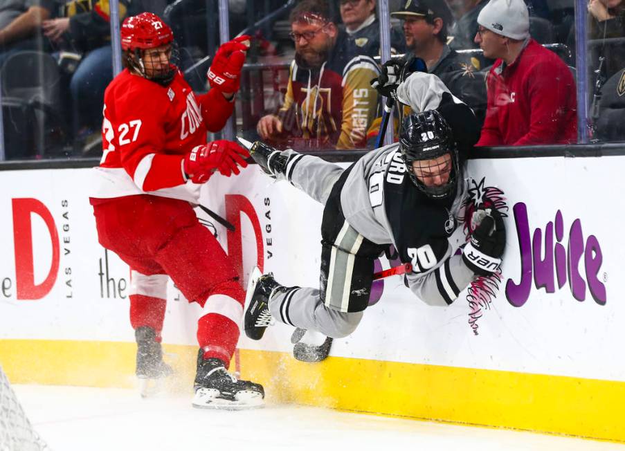 Providence Friars' Parker Ford (20) gets tripped up in front of Cornell Big Red's Morgan Barron ...