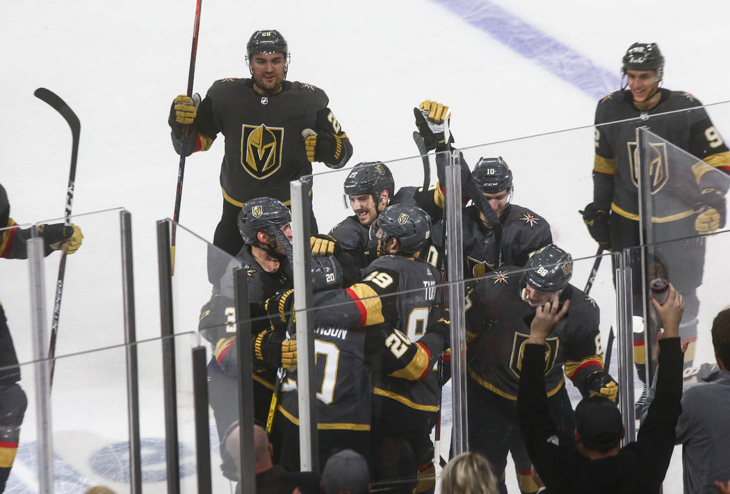 The Golden Knights celebrate a goal by Chandler Stephenson (20) to win in overtime against the ...