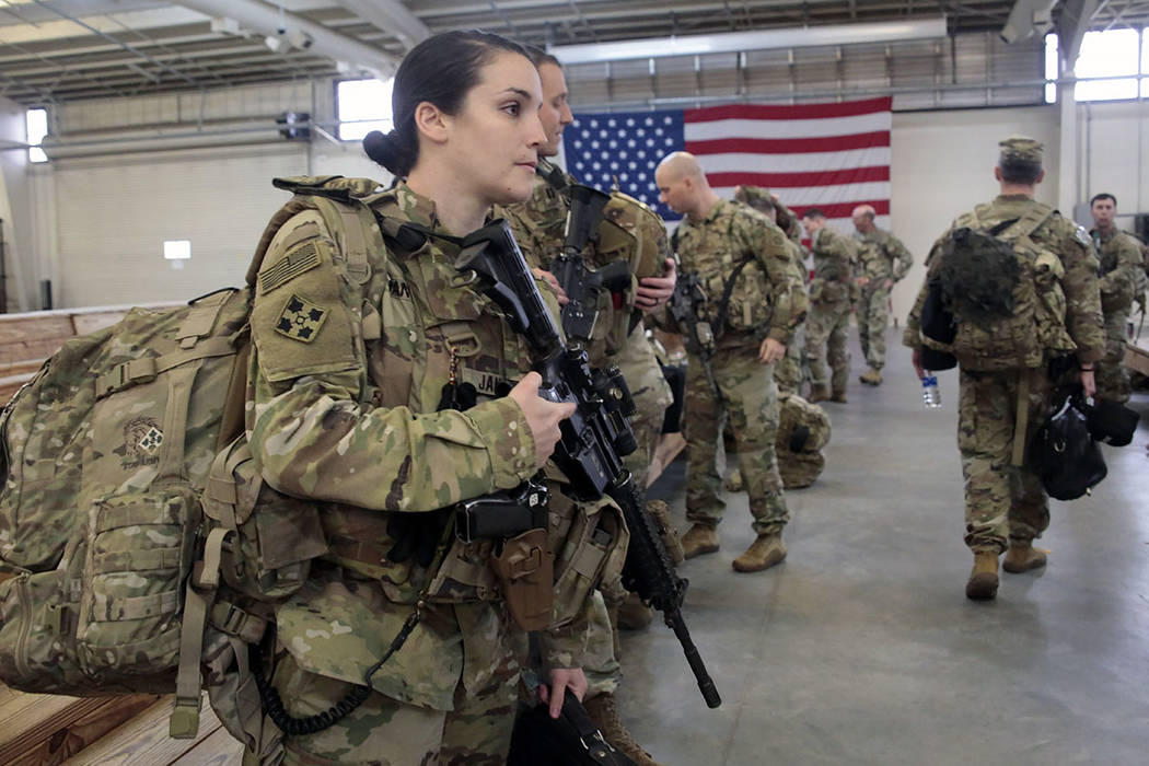 Soldiers don their gear Saturday, Jan. 4, 2020, at Fort Bragg, N.C., as troops from the 82nd Ai ...