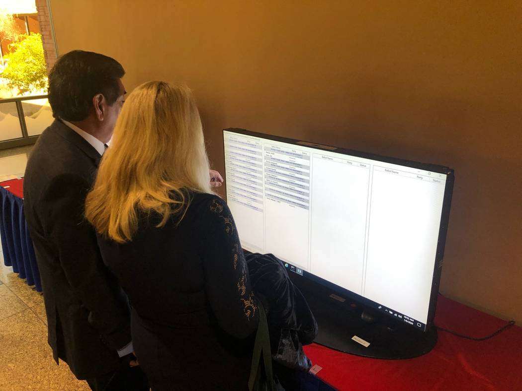 Family Court Judge Vincent Ochoa and wife Debra look for his name among a screen of judicial ca ...
