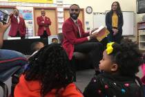 Evan Jackson Jr. with Kappa Alpha Psi reads to students at Booker Elementary School.