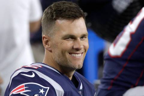 New England Patriots quarterback Tom Brady sits on the bench in the second half of an NFL prese ...