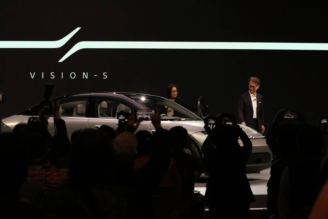Sony Corporation CEO Kenichiro Yoshida, right, looks over the Vision-S sedan, a car protoype cr ...